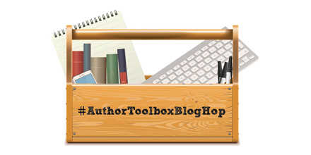 A photoshopped image of a wooden toolbox which has a notepad, five books, an iphone, a mac keyboard, and three black pens inside of it. On the front of the toolbox is written "#AuthorToolboxBlogHop"